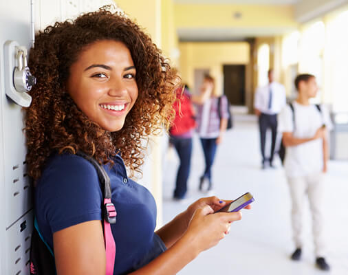 High school students using MoneyEdu between classes