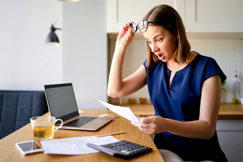 A woman surprised by her credit card bill.